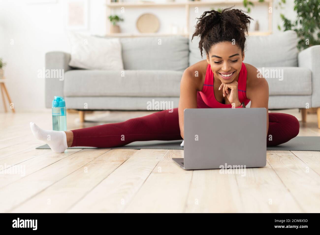 Fit African American Woman Exercising At Laptop Training At Home Stock Photo