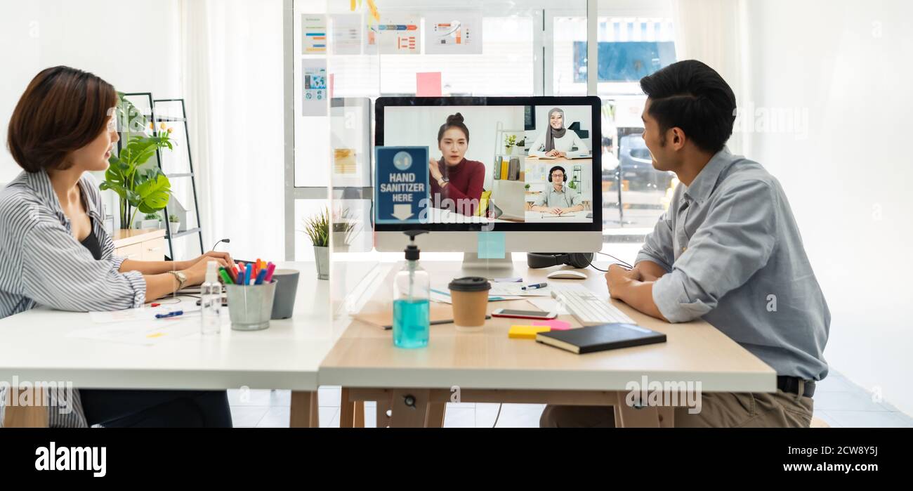Panorama two asian businessperson work from home involved video conference meeting to corporate colleague for discuss and brainstorm distantly. This t Stock Photo