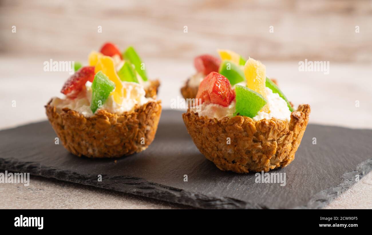 healthy and sweet breakfast. quick and easy recipe for homemade cupcake. summer dessert for children. oatmeal baskets Stock Photo