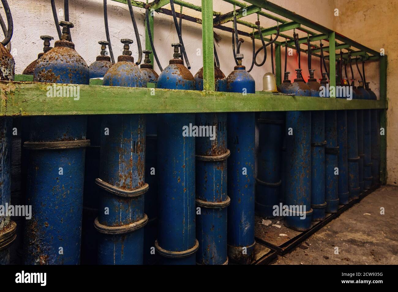 Old rusty bundle of blue gas cylinders Stock Photo