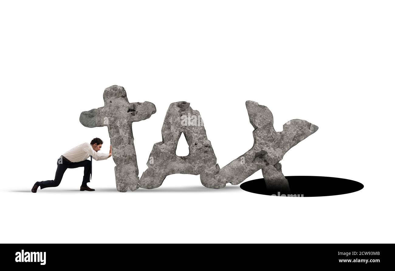 Businessman pushes the word TAX made of heavy rock in a black hole Stock Photo