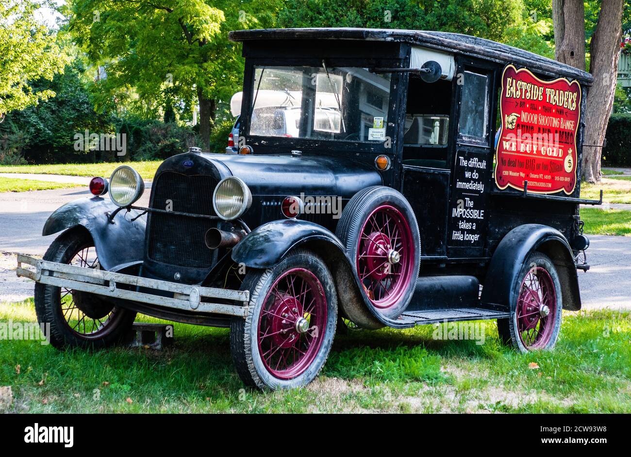 An antique truck carries an old advertisement - 3 Stock Photo