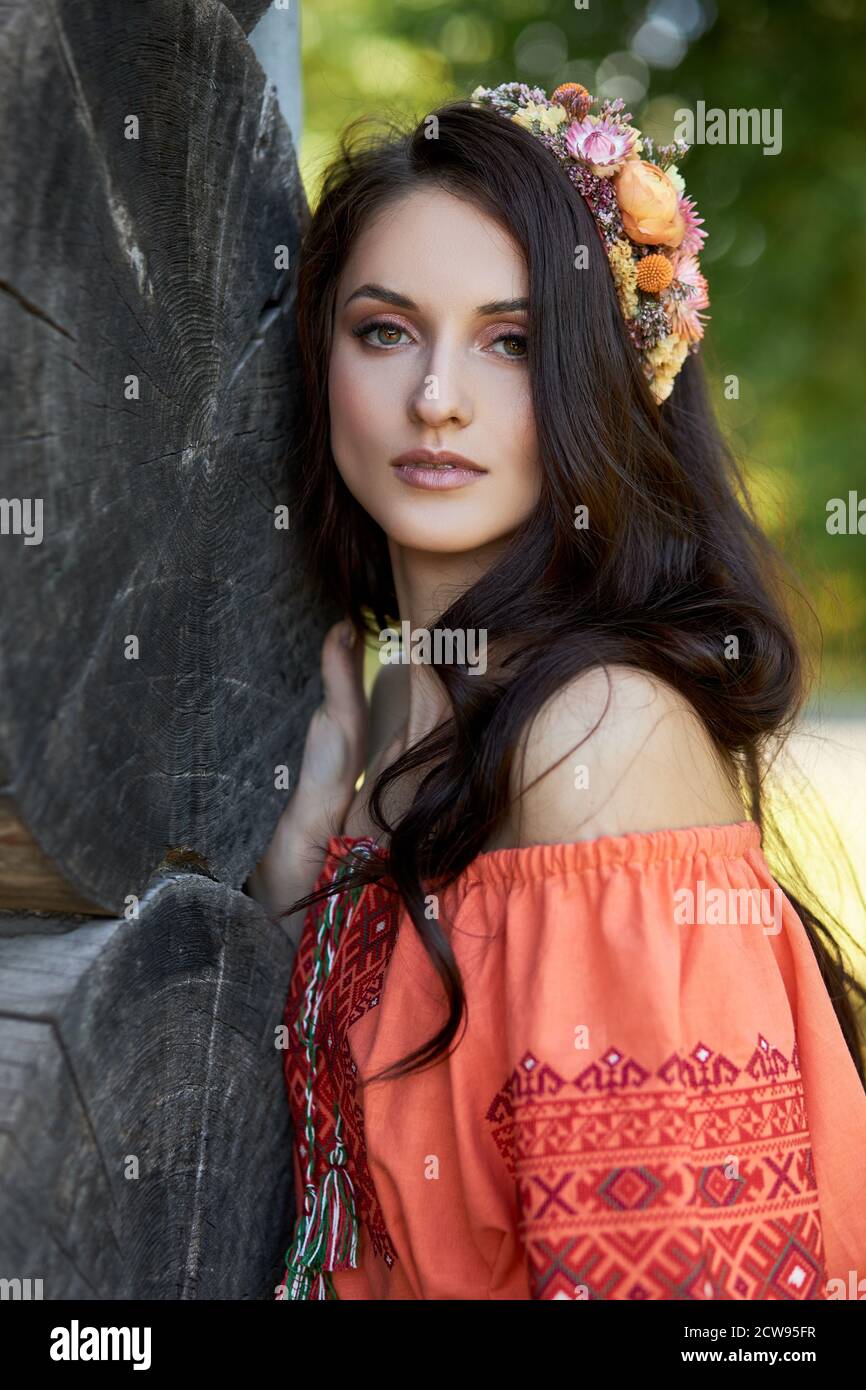 https://c8.alamy.com/comp/2CW95FR/beautiful-slavic-woman-in-an-orange-ethnic-dress-and-a-wreath-of-flowers-on-her-head-beautiful-natural-makeup-portrait-of-a-russian-girl-2CW95FR.jpg