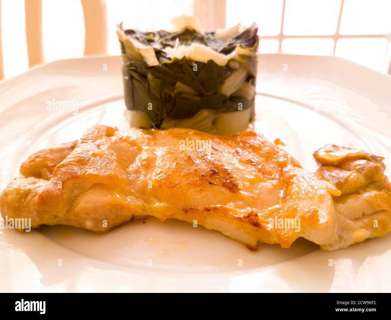 Grilled chicken garnished with chard. An ideal meal to follow a healthy and balanced diet Stock Photo