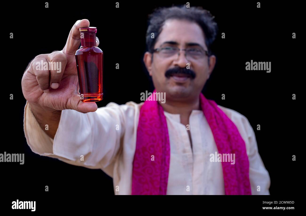 Senior man holding something with hand showing at camera Stock Photo