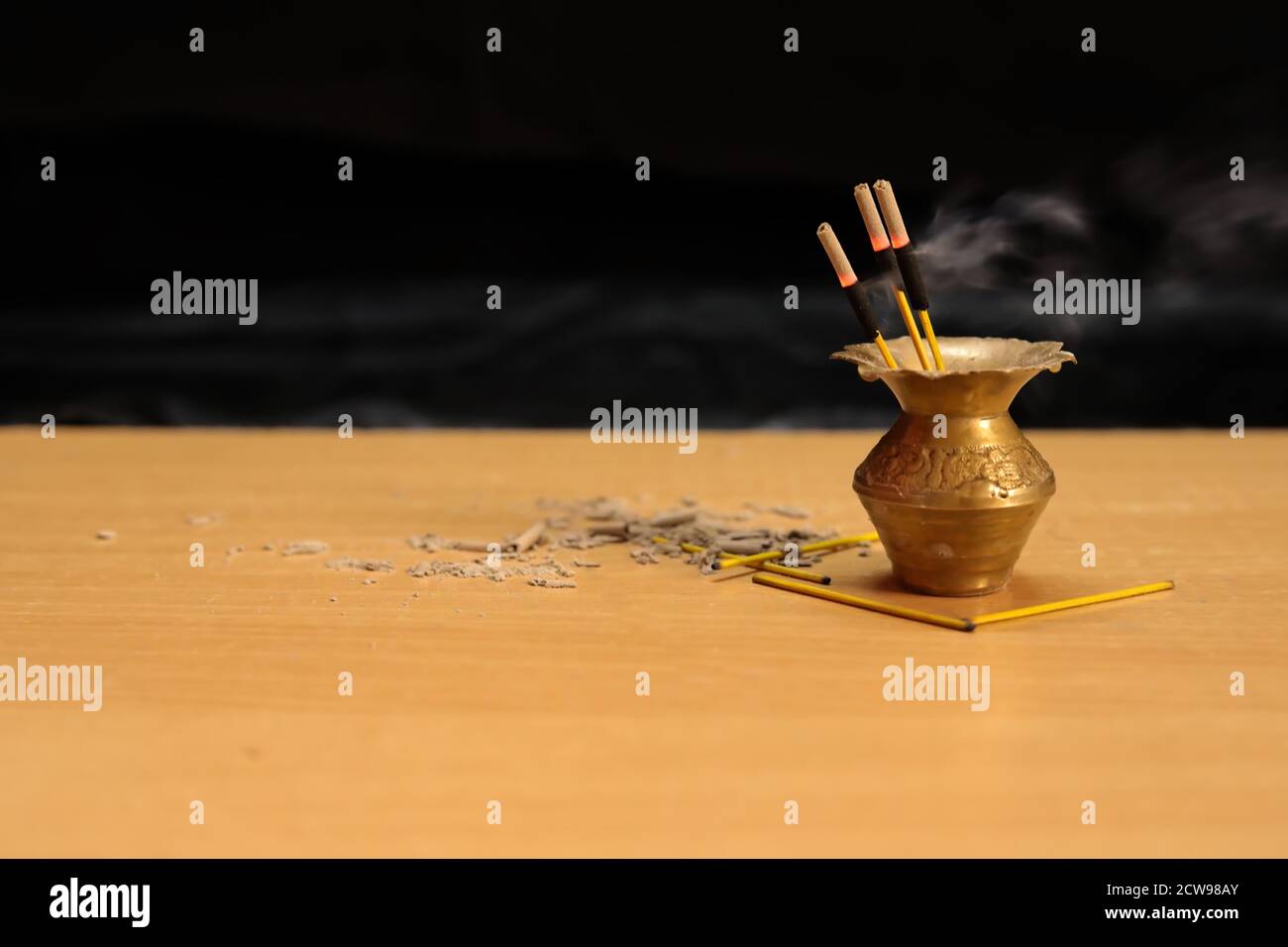 Reed diffuser on wooden table in room on a black wall. Handmade reed freshener Stock Photo