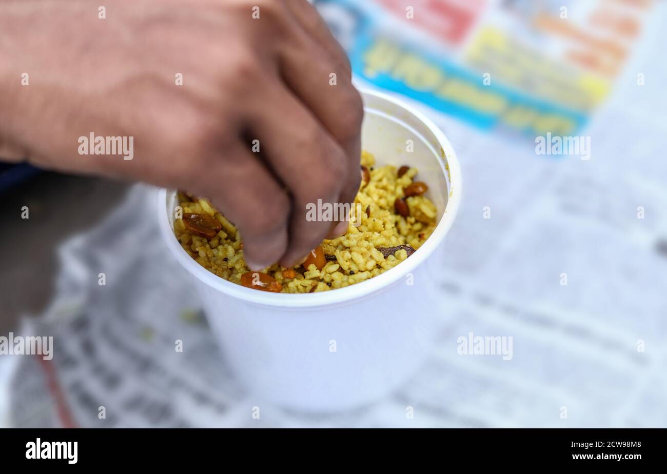 Overhead view of Indian man hand eating Tamarind Rice on ground Stock ...