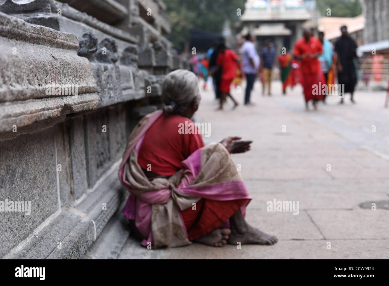 Old woman Beggars Sitting inside a Temple Stock Photo