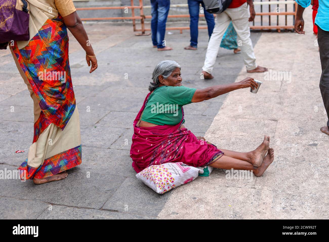 Old woman Beggars Sitting inside a Temple Stock Photo