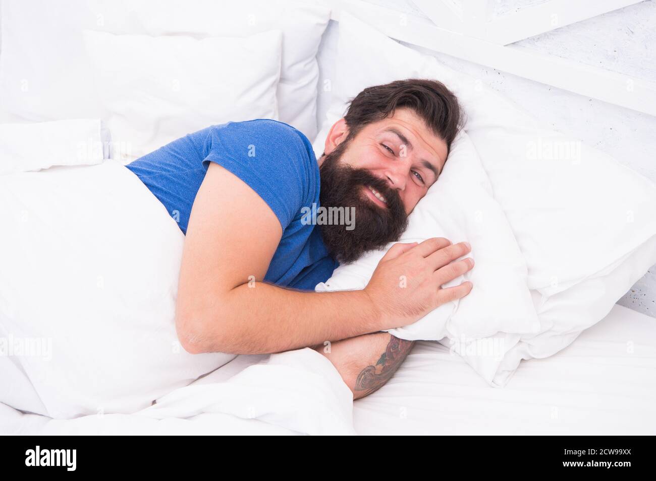 Just relaxing. bachelor feel comfortable. guy at bedroom. lazy sunday. bed time routine. smiling male spending time in room. relax lifestyle. happy bearded man in bed. wake up at morning. Stock Photo