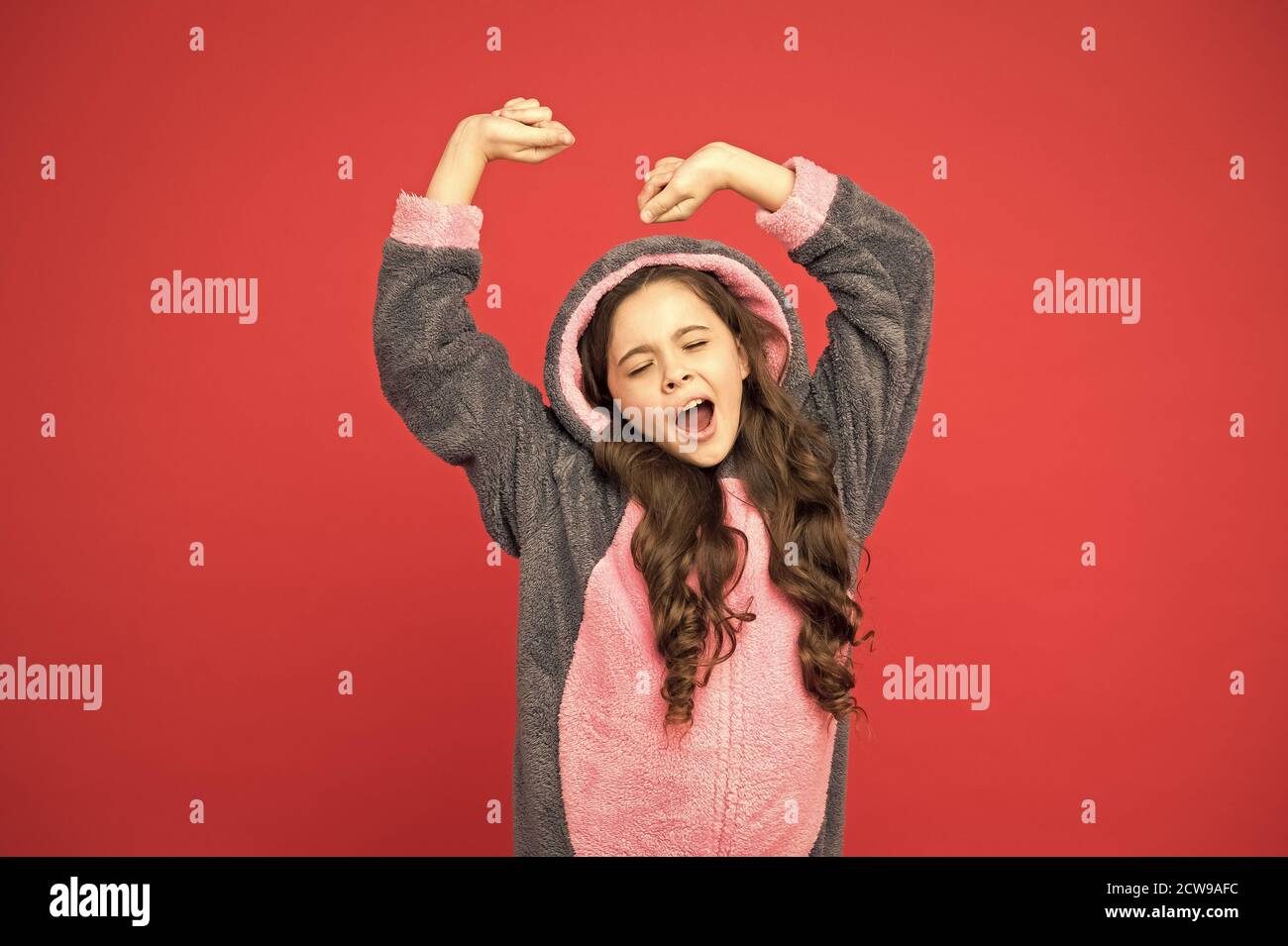 Comfortable soft pajamas. Good morning. Girl in bunny pajamas. Child in rabbit kigurumi. Happy girl in cute pajamas. Lifestyle concept. Rest and relax. Baby animal character role. Time to sleep. Stock Photo