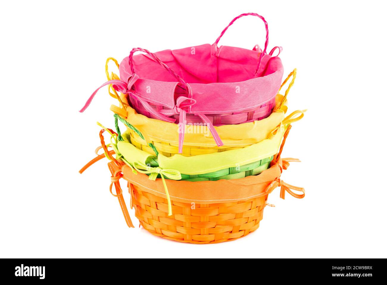 Stack of four colorful empty wicker baskets isolated on white background. Stock Photo
