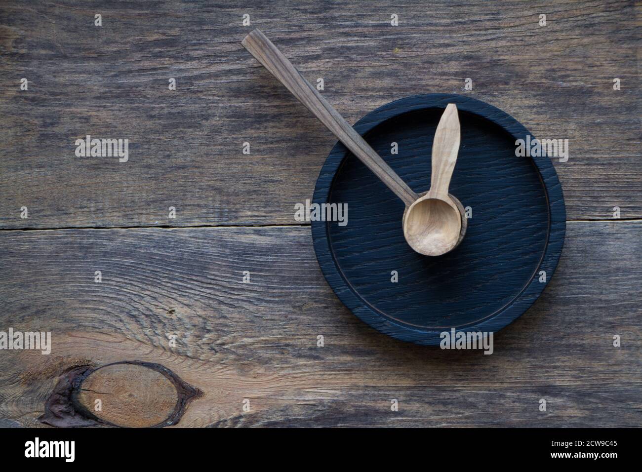 Top view two wooden spoons inside of cup holder clock-shaped, eco friendly cutlery concept, selective focus Stock Photo