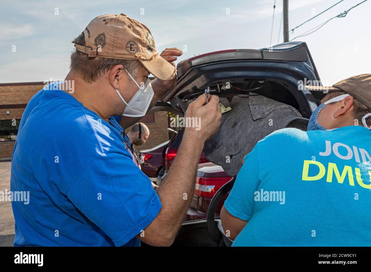 Ypsilanti, Michigan - Professional and amateur auto mechanics made free car repairs at a Pull Over Prevention Clinic. The event aimed to help communit Stock Photo