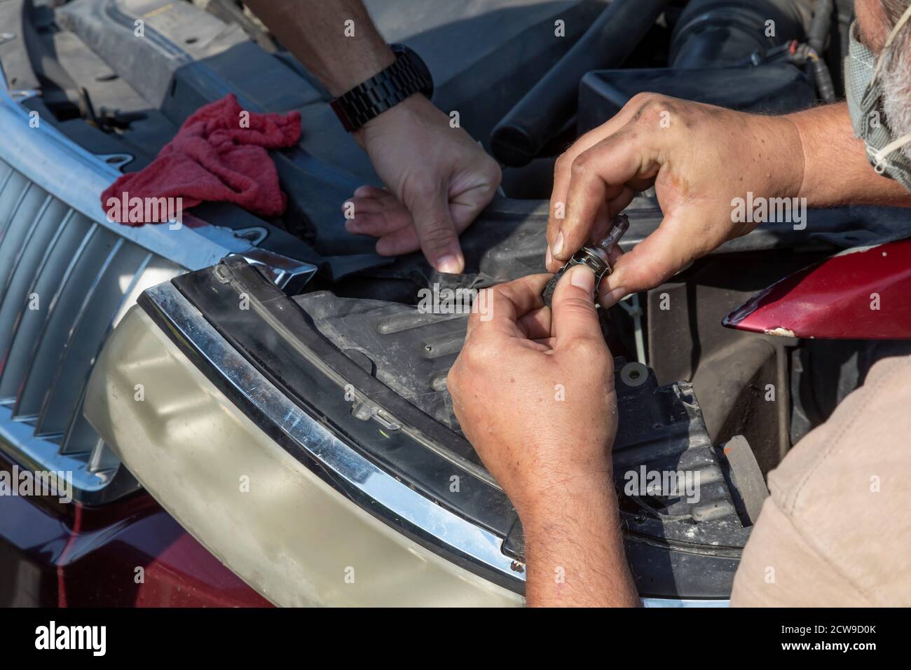 Ypsilanti, Michigan - Professional and amateur auto mechanics made free car repairs at a Pull Over Prevention Clinic. The event aimed to help communit Stock Photo