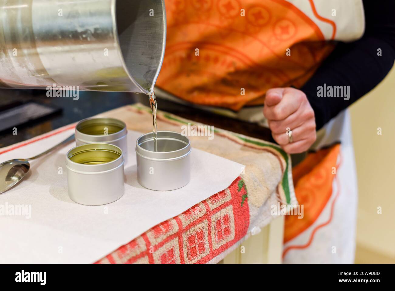 Creative occupation of candle making showing the pouring of liquid wax