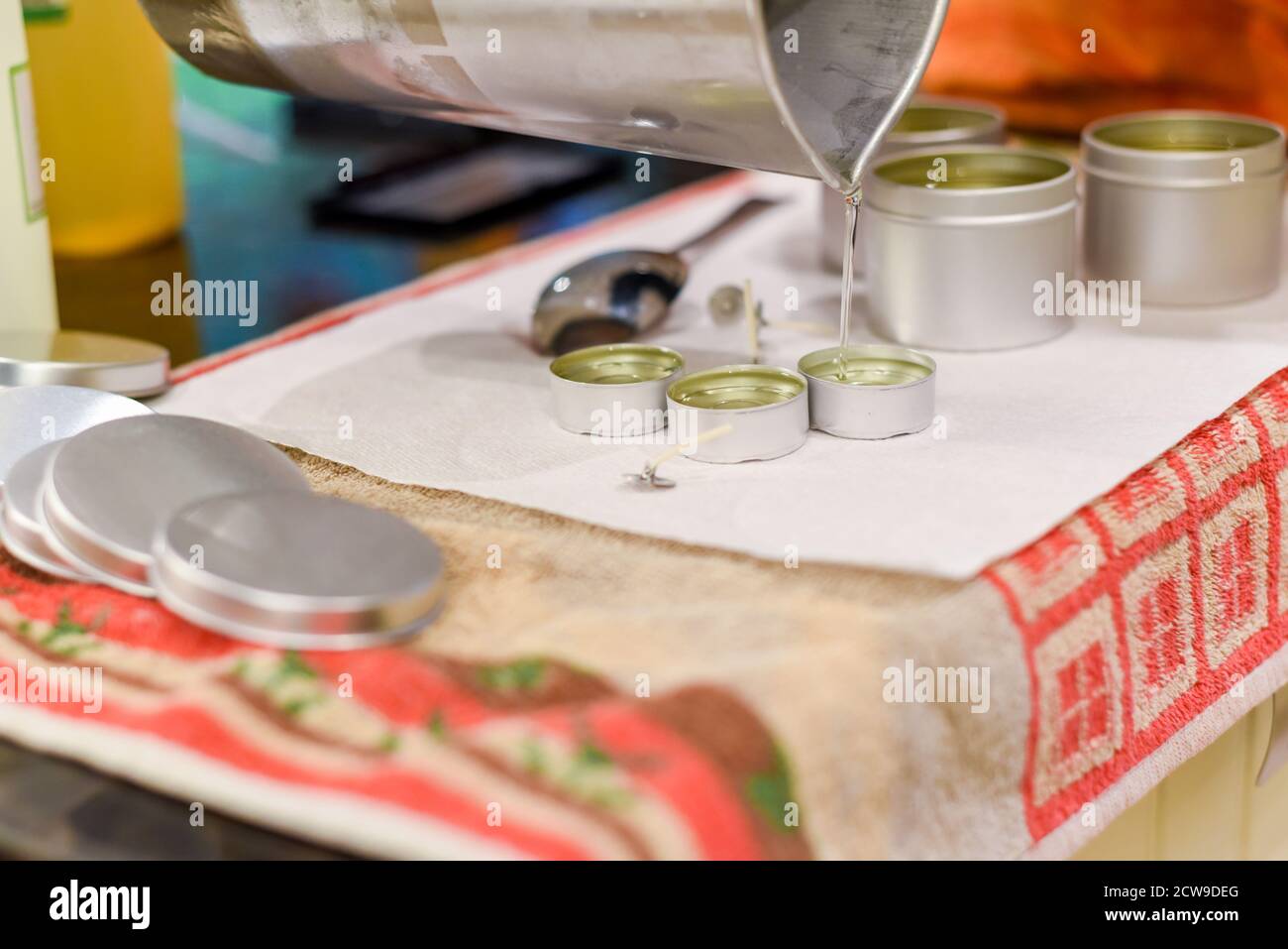 Creative occupation of candle making showing the pouring of liquid wax