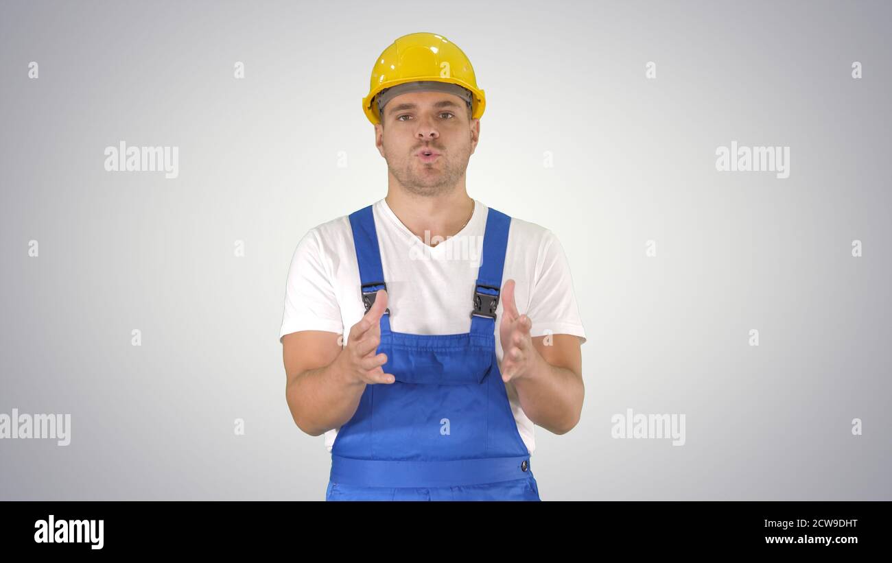 Foreman builder explaining something to camera and talking on gr Stock Photo