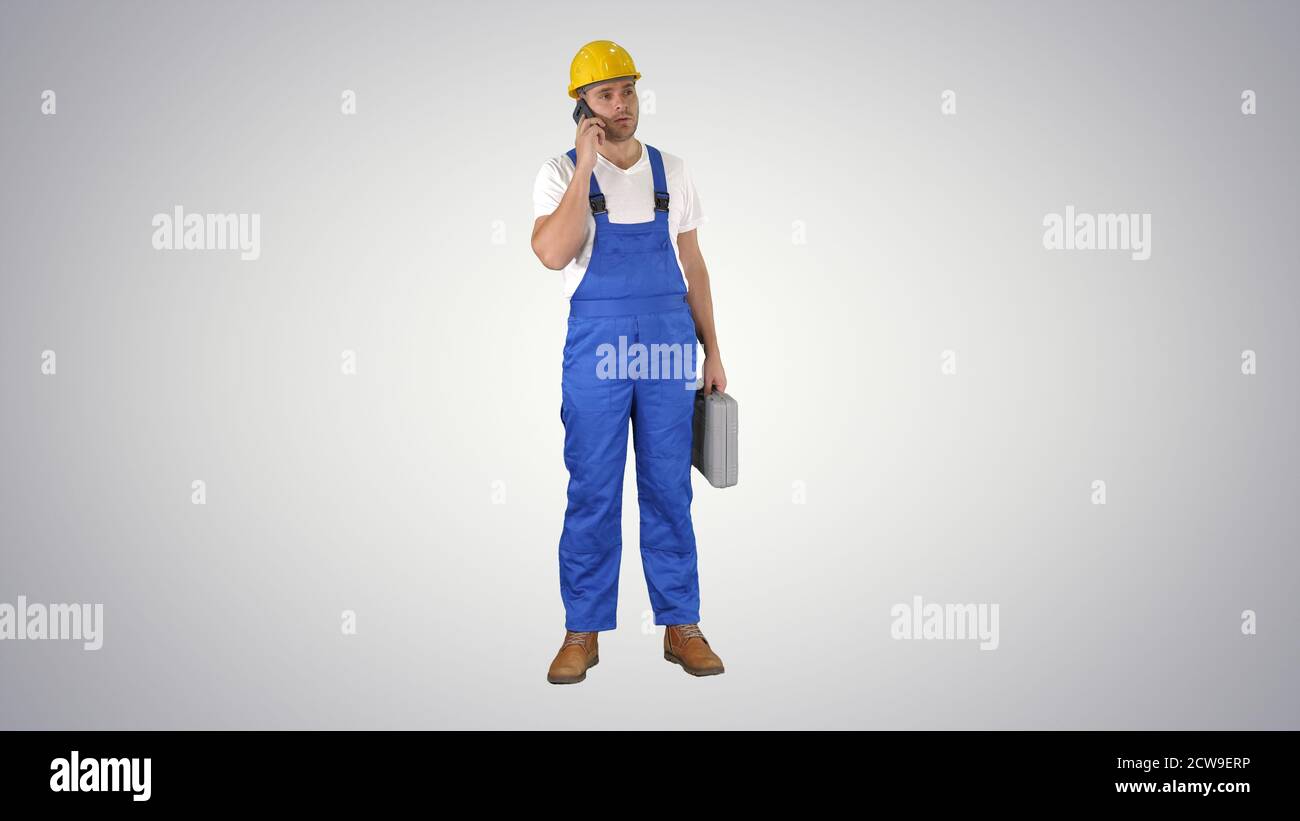 Construction Worker On Telephone on gradient background. Stock Photo
