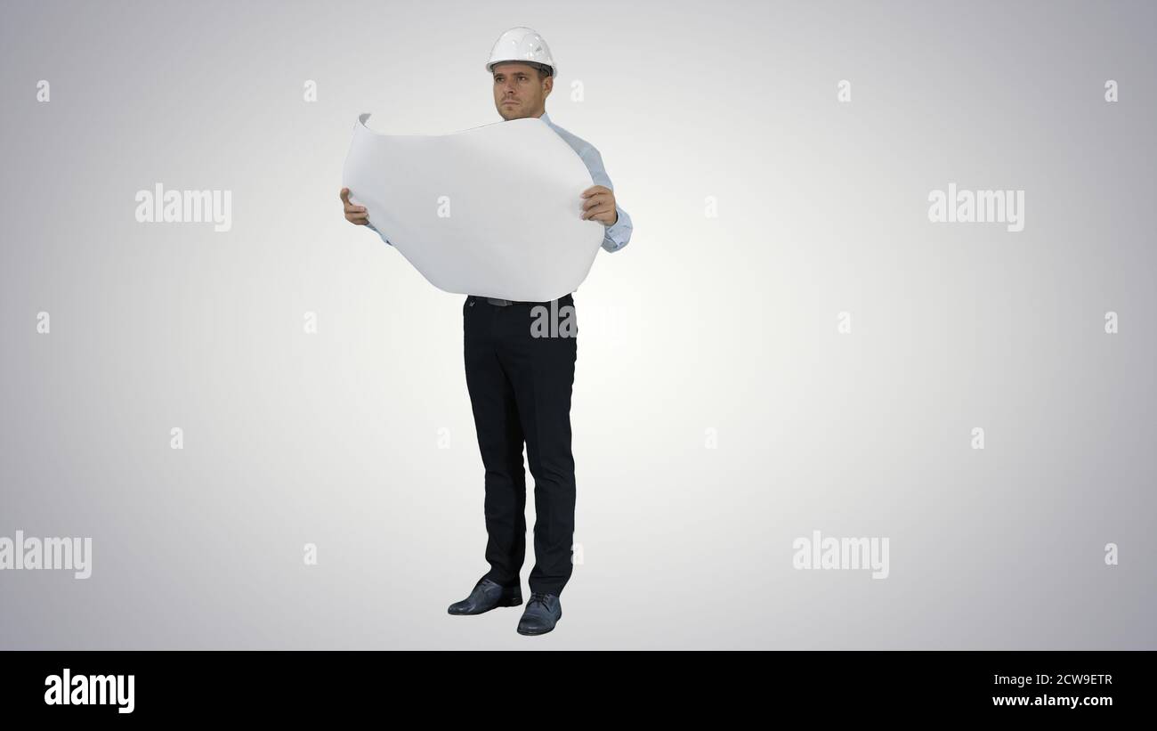 Engineer checking construction plan with what is built on gradie Stock Photo