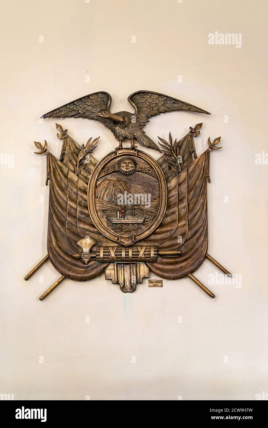 Quito, Ecuador - December 2, 2008: Closeup of bronze Coat do Arms against beige wall at Presidential Carondelet Palace. Stock Photo