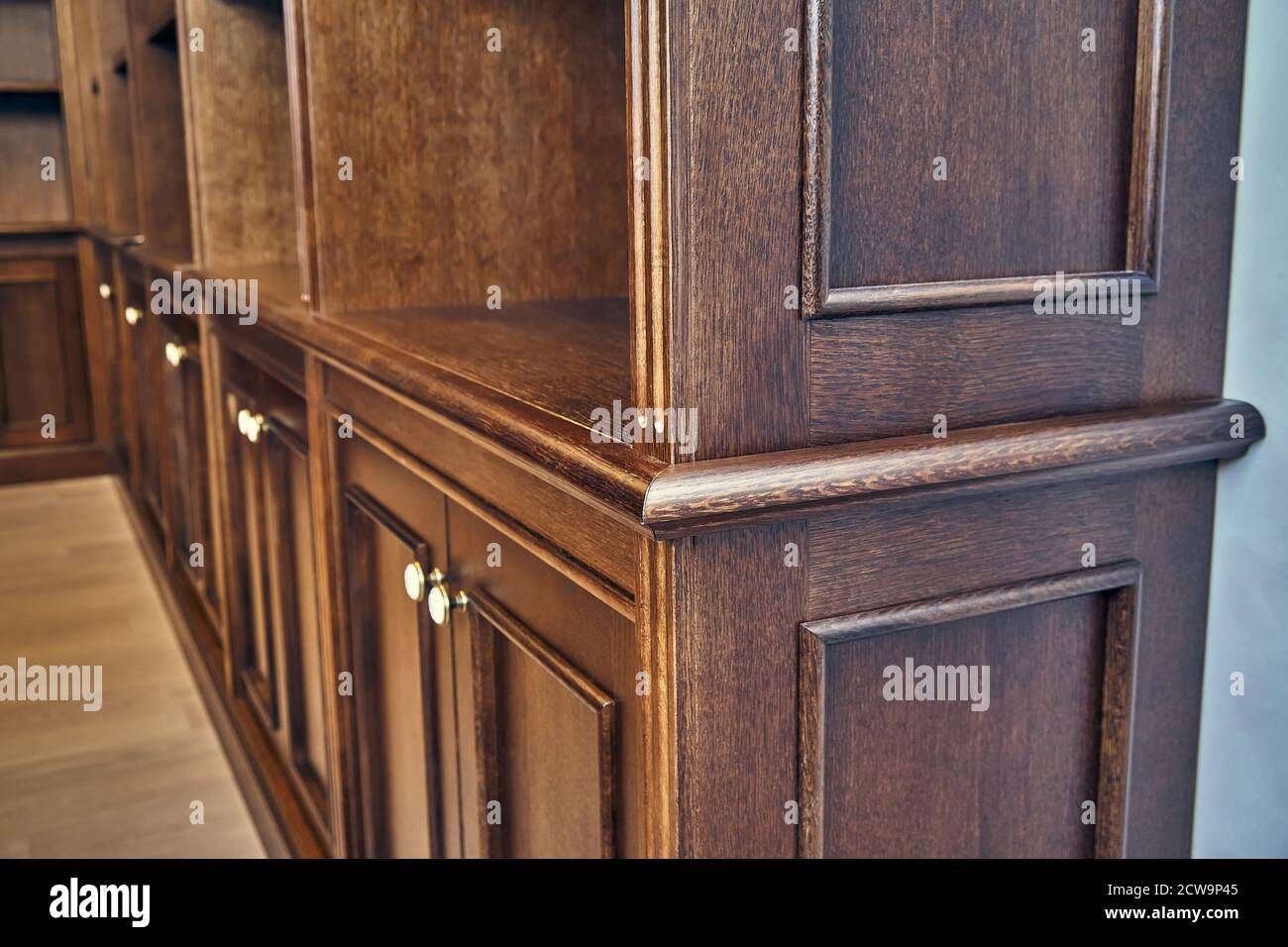Home library. Detail of antique wooden bookcase with empty shelves placed in home library in house Stock Photo
