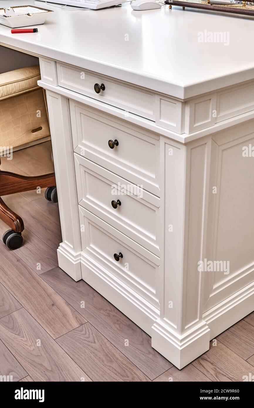 White wooden classic writing desk with drawers in home office Stock Photo