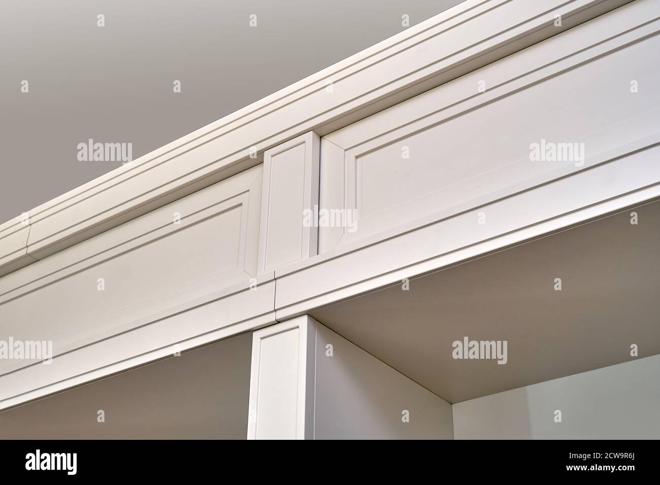 Detail of white wooden bookcase with empty shelves in home library Stock Photo