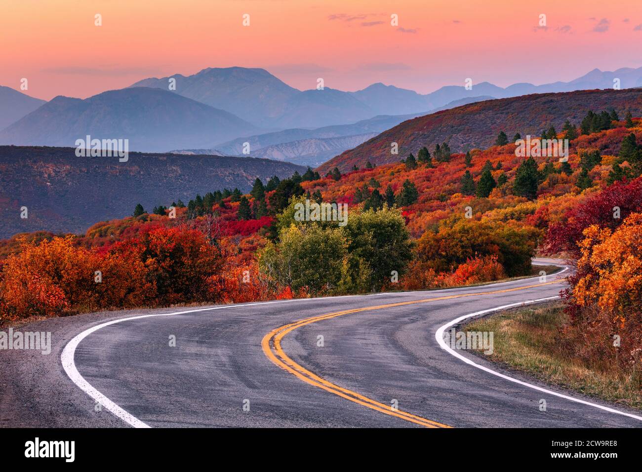 Winding mountain road through a scenic autumn landscape along the West Elk Loop near Gunnison, Colorado. Stock Photo