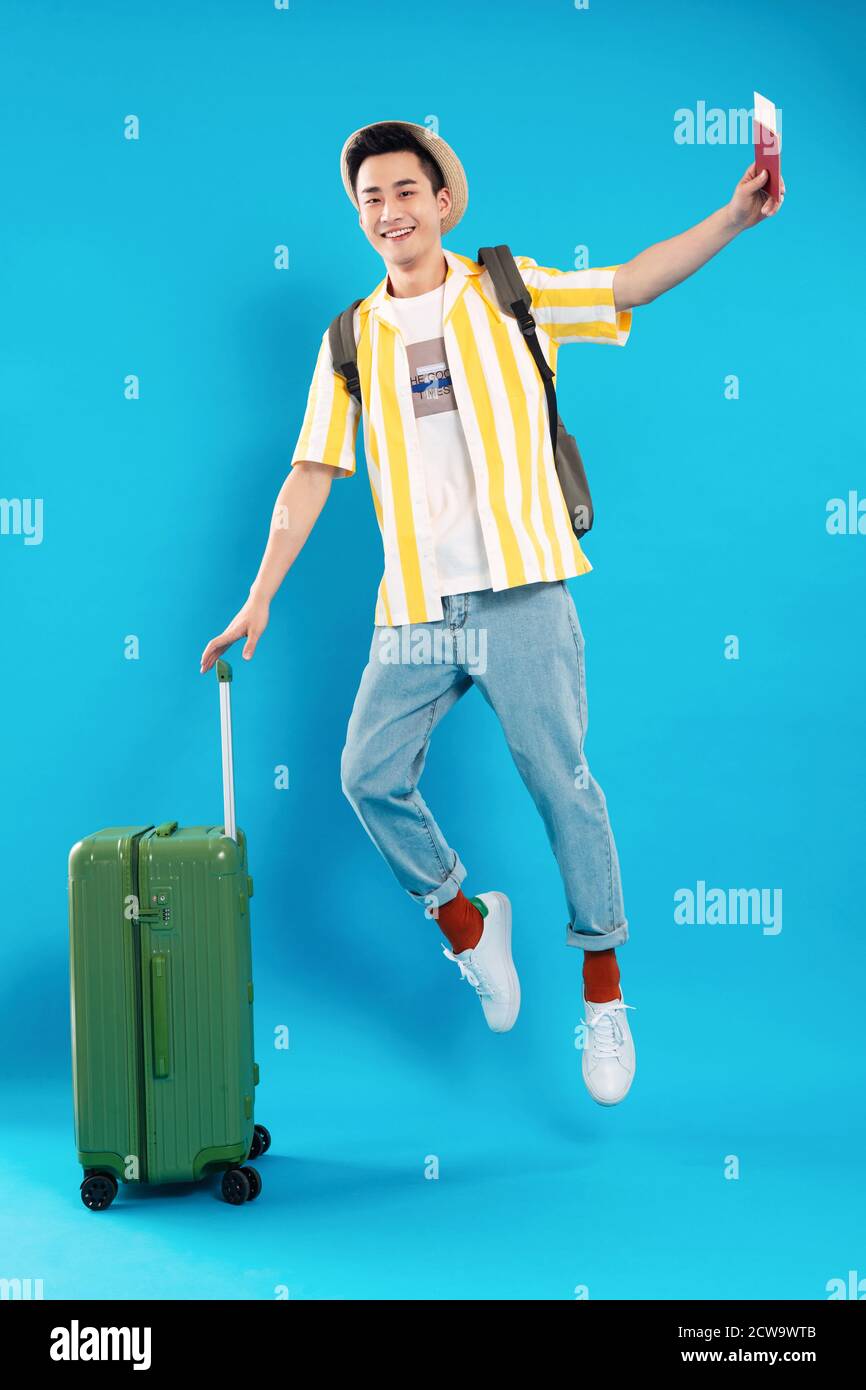 Hold the suitcase bouncing young man Stock Photo