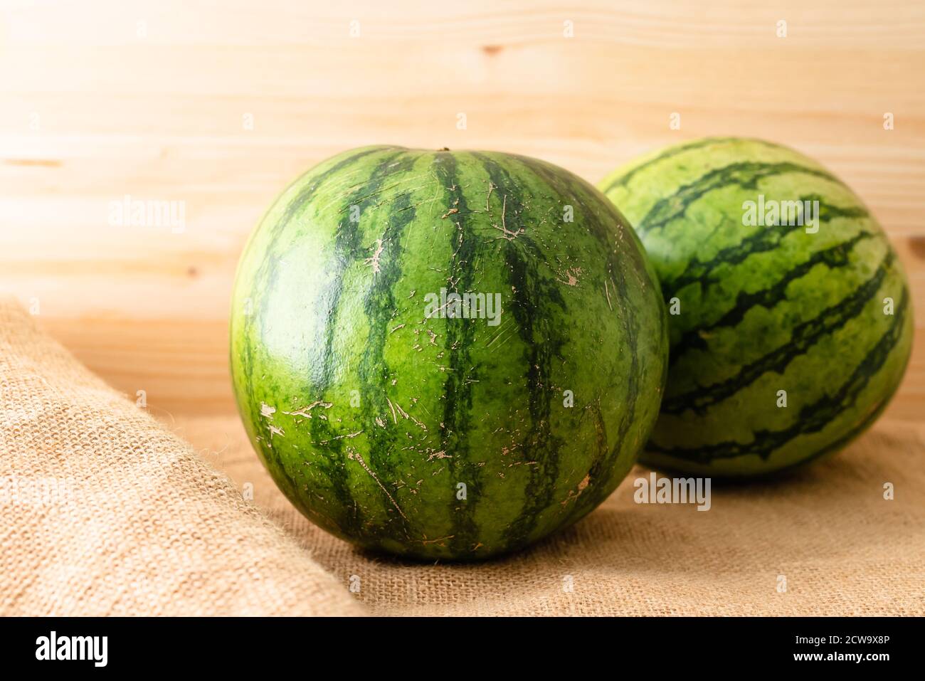 Watermelon close up. Two ripe organic watermelons on rustic wooden background Stock Photo