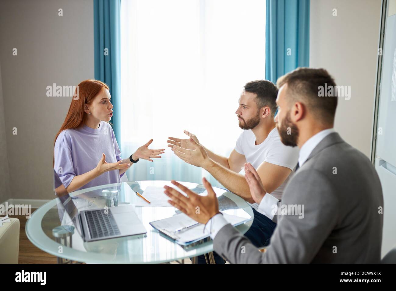 young caucasian couple visiting professional lawyer, refuse sign decree paper and finalize divorce. at marriage consultant or agent office. family separation, divorce concept Stock Photo