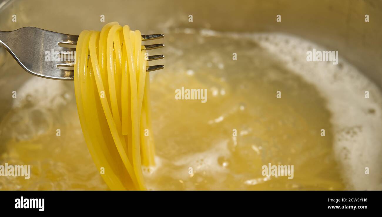 boiling pasta spaghetti in pot. penne rigate pasta Cooking pasta in