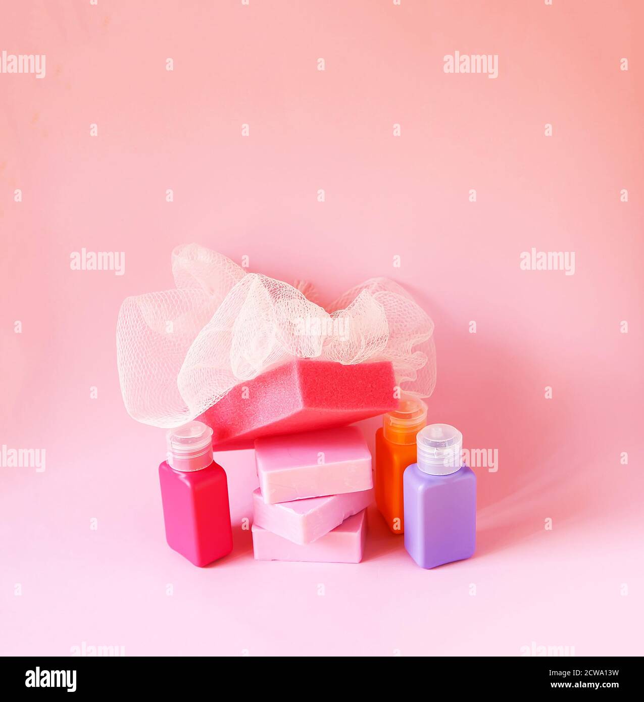 Colorful washcloth, plastic small travel bottles and bars of soap on a