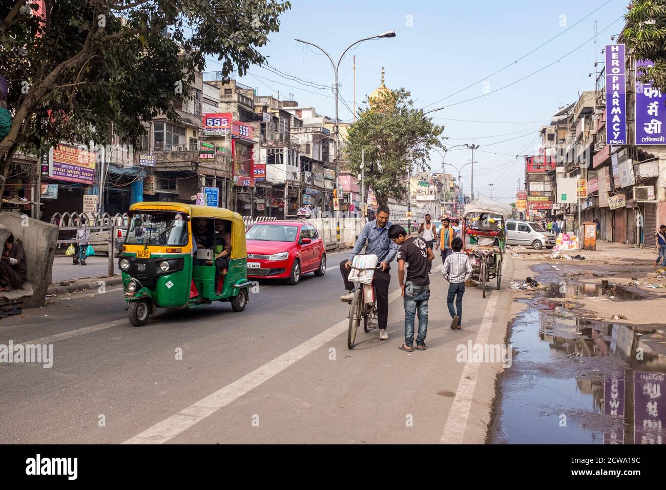 Busy Chandni Chowk Road with tuktuks, cars and pedestrians in New