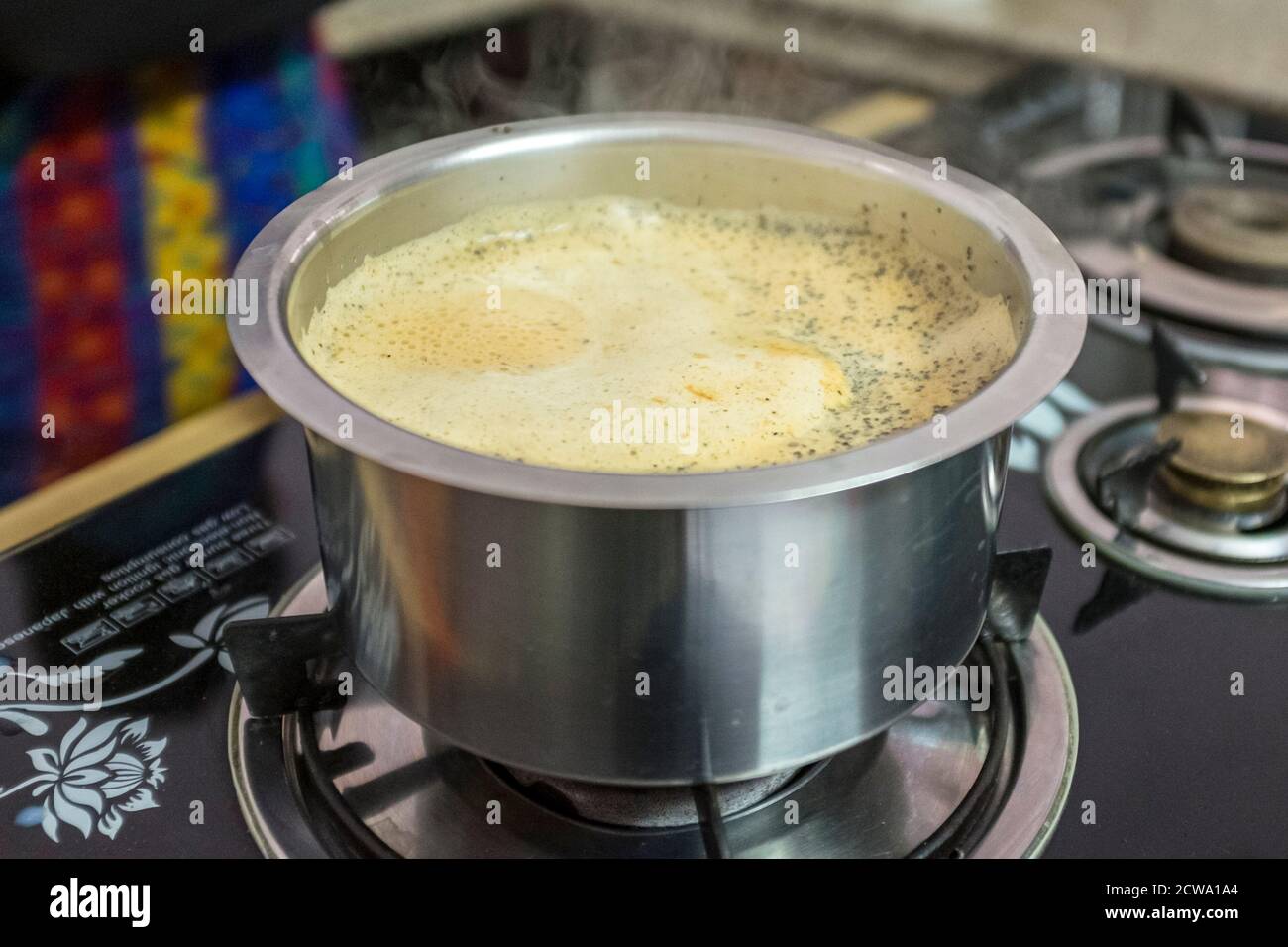 Masala Chai simmering in a pot on a stove in India Stock Photo Alamy