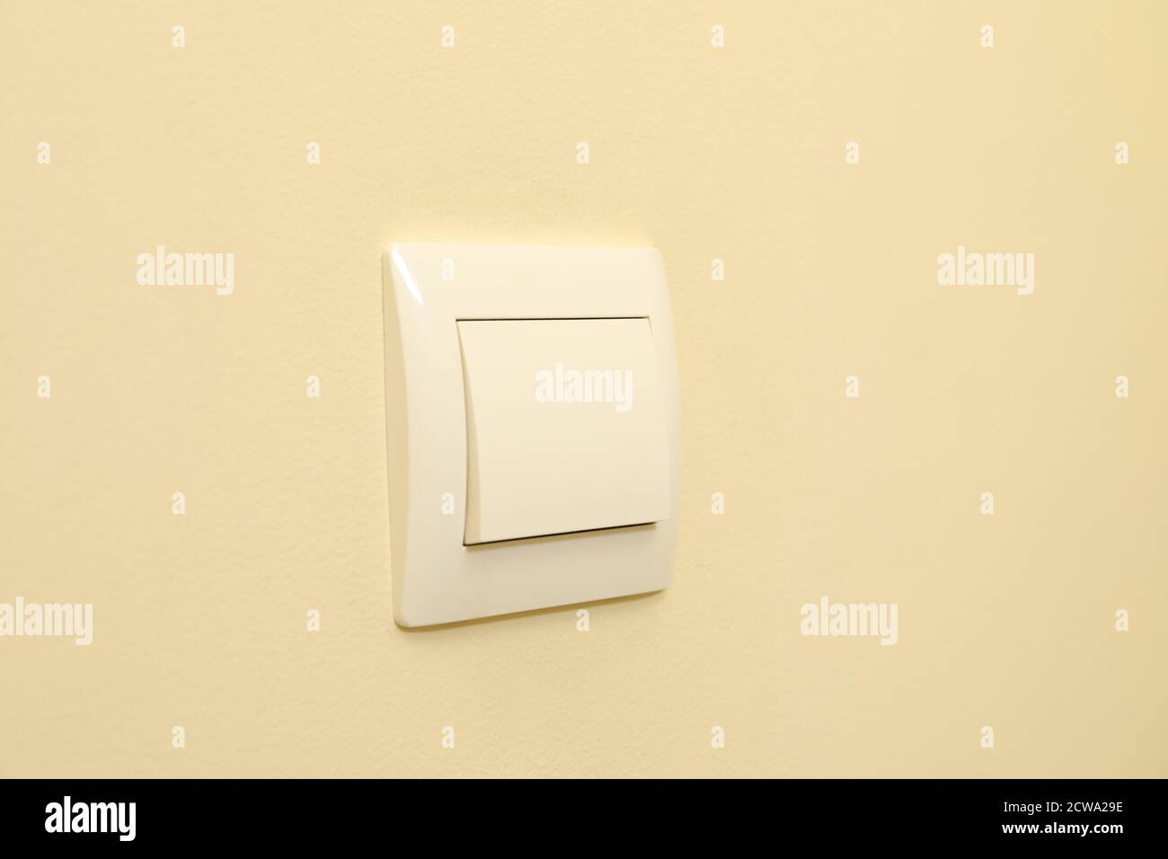 On-Off light switch on the beige wall Stock Photo - Alamy
