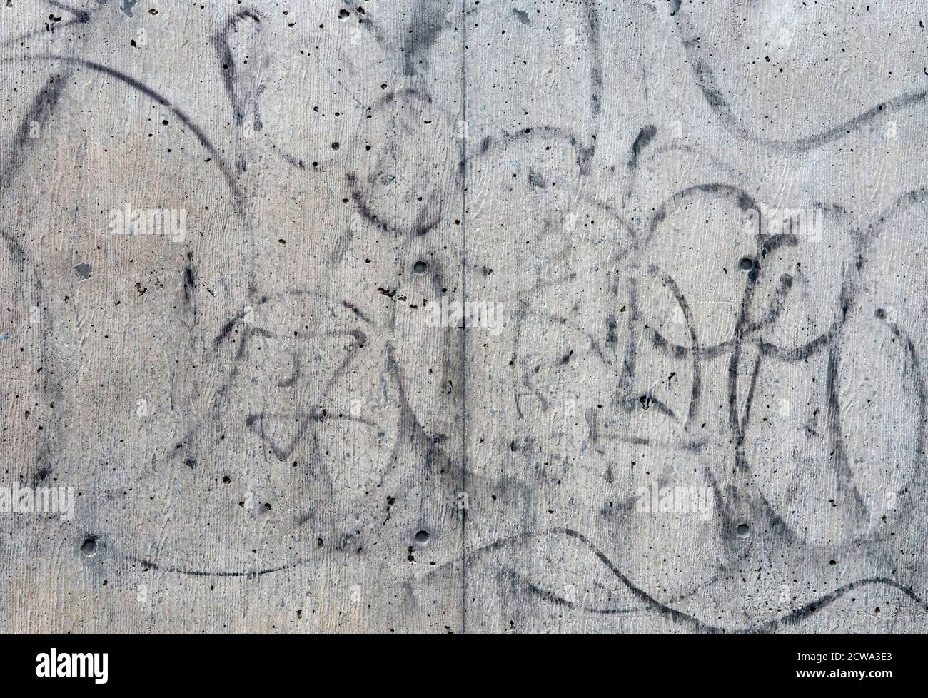 A Close Up Of Partially Removed Graffiti On A Concrete Wall Stock Photo
