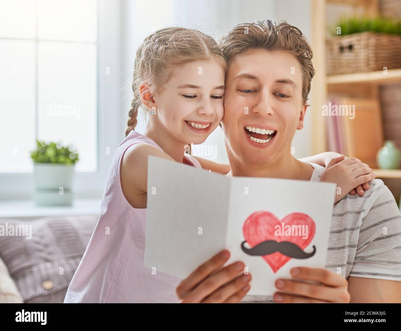 Happy father's day! Child daughter congratulates dad and gives him ...