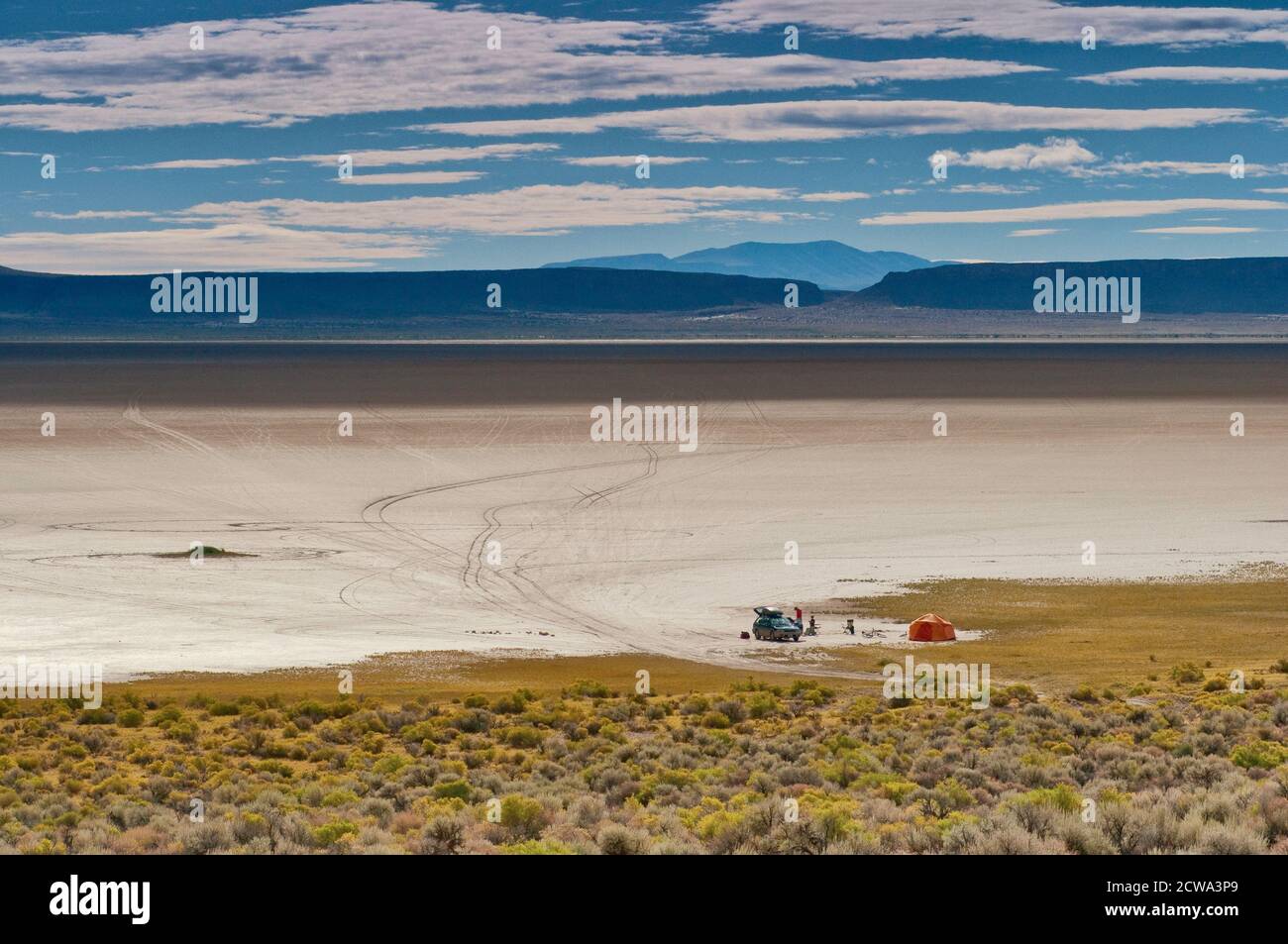 Campers on edge of dry Alvord Lake at Alvord Desert seen from East Steens Road near Steens Mountain, Great Basin Desert region, Oregon, USA Stock Photo