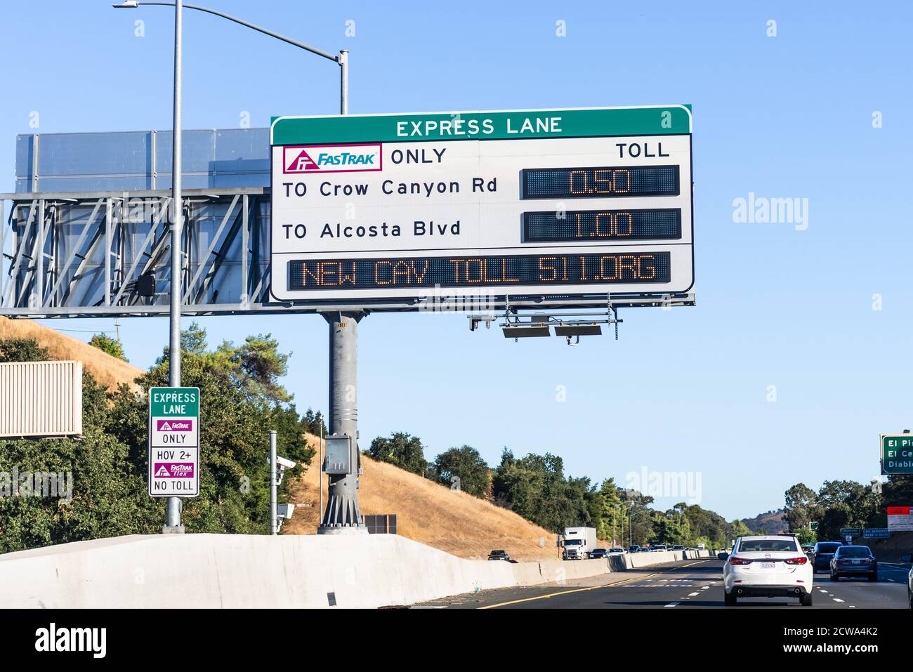 Sep 23, 2020 San Ramon / CA / USA - Freeway Express Lane sign displaying the next exits and the applicable fees, plus a message about the new CAV (Cle Stock Photo