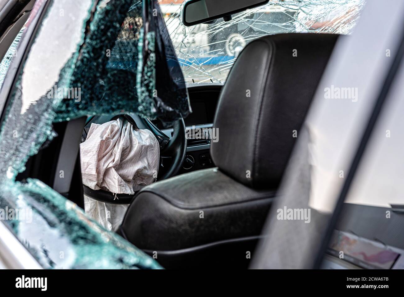 damaged vehicle closeup after a heavy crash, car wreck, exploded airbag ...