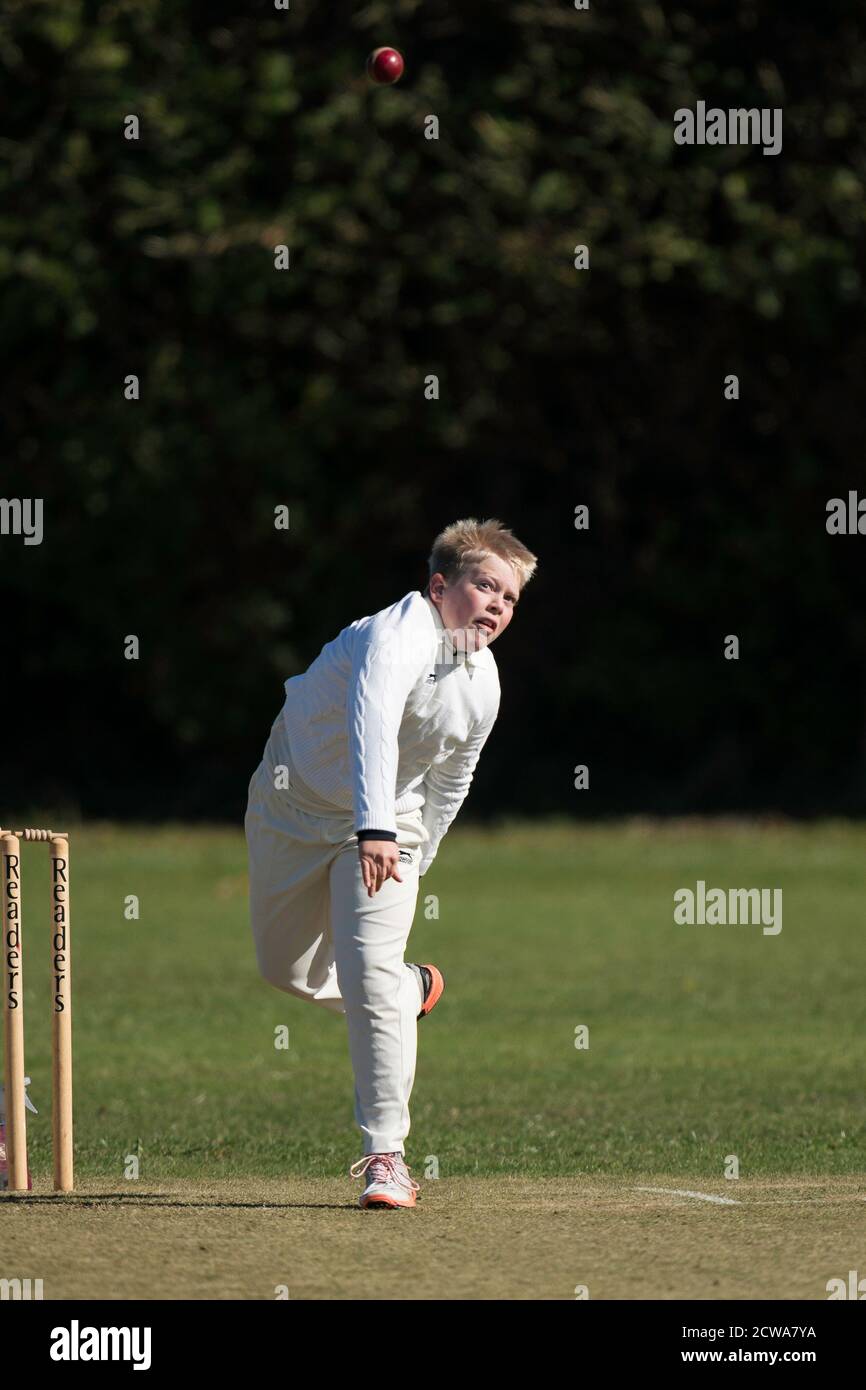 Junior spin bowler in action Stock Photo