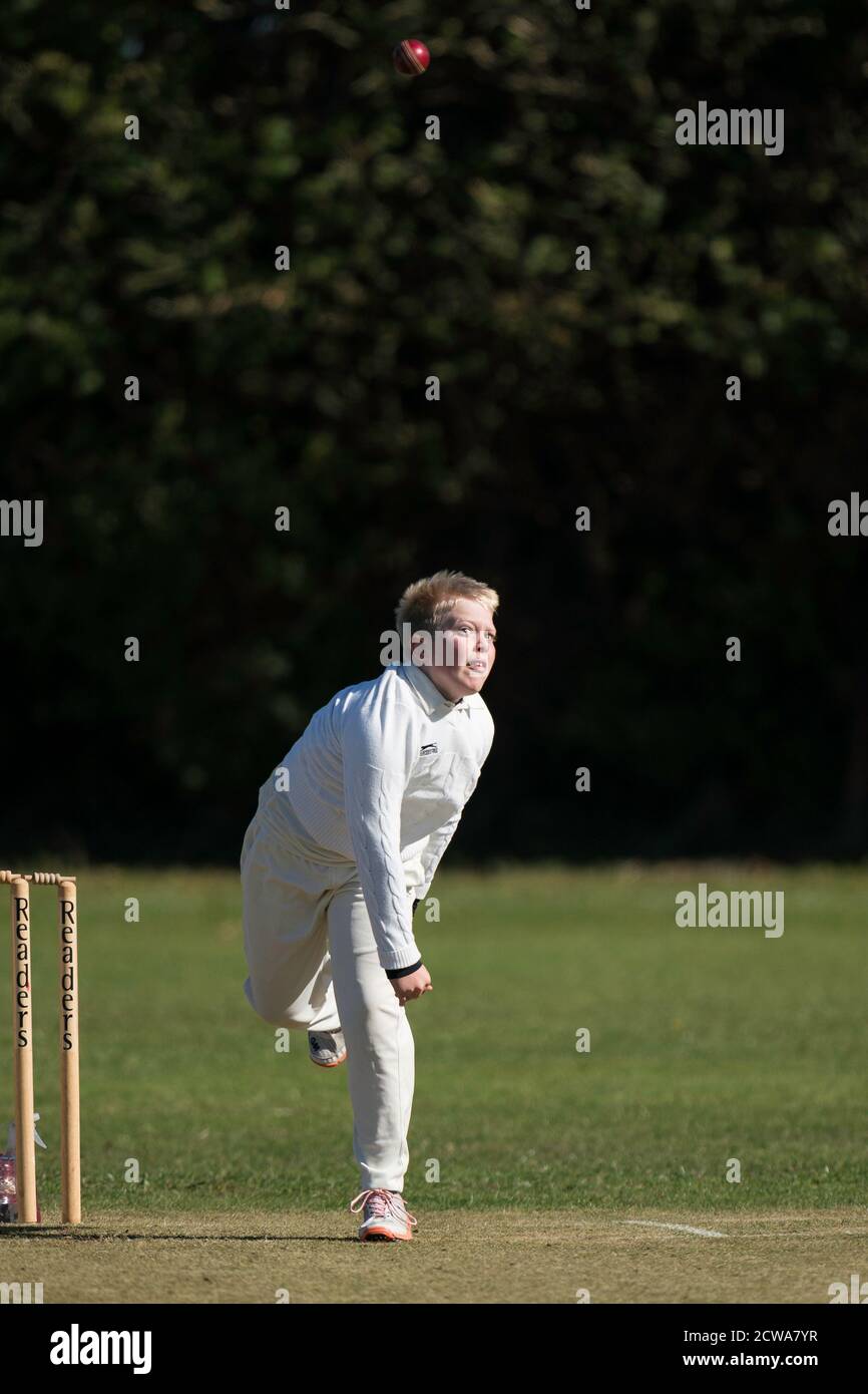 Junior spin bowler in action Stock Photo