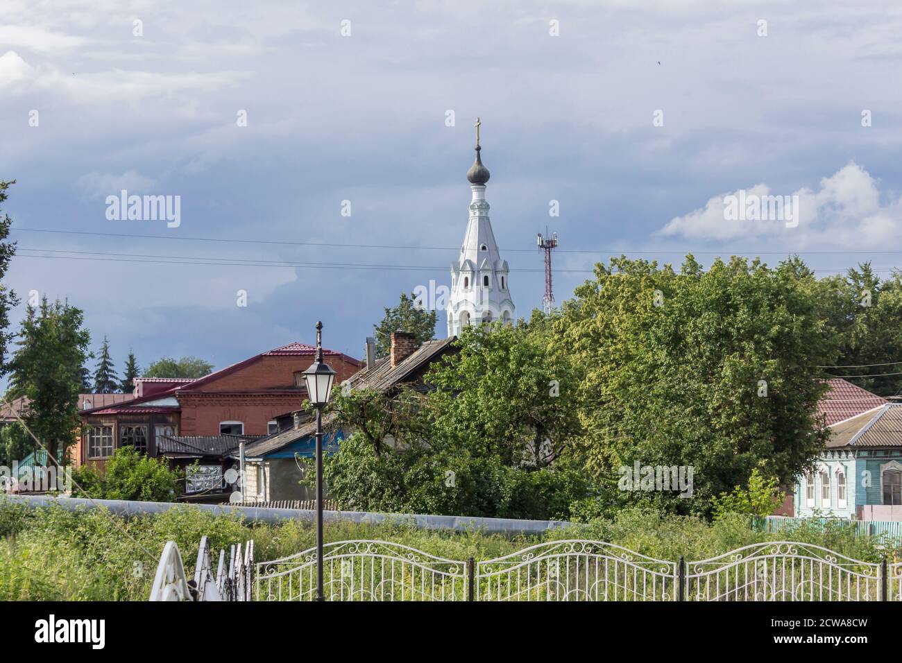 Bell tower among the urban landscape. Nineteenth century architecture. Provincial town of Borovsk in Russia. Stock Photo