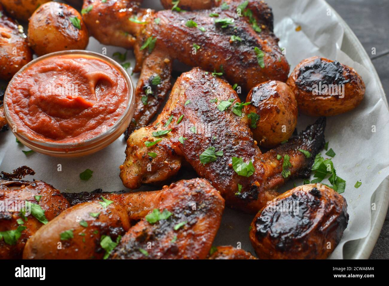 Chicken wings baked in soy-honey sauce. Fried chicken wings in a plate. Closeup. Stock Photo