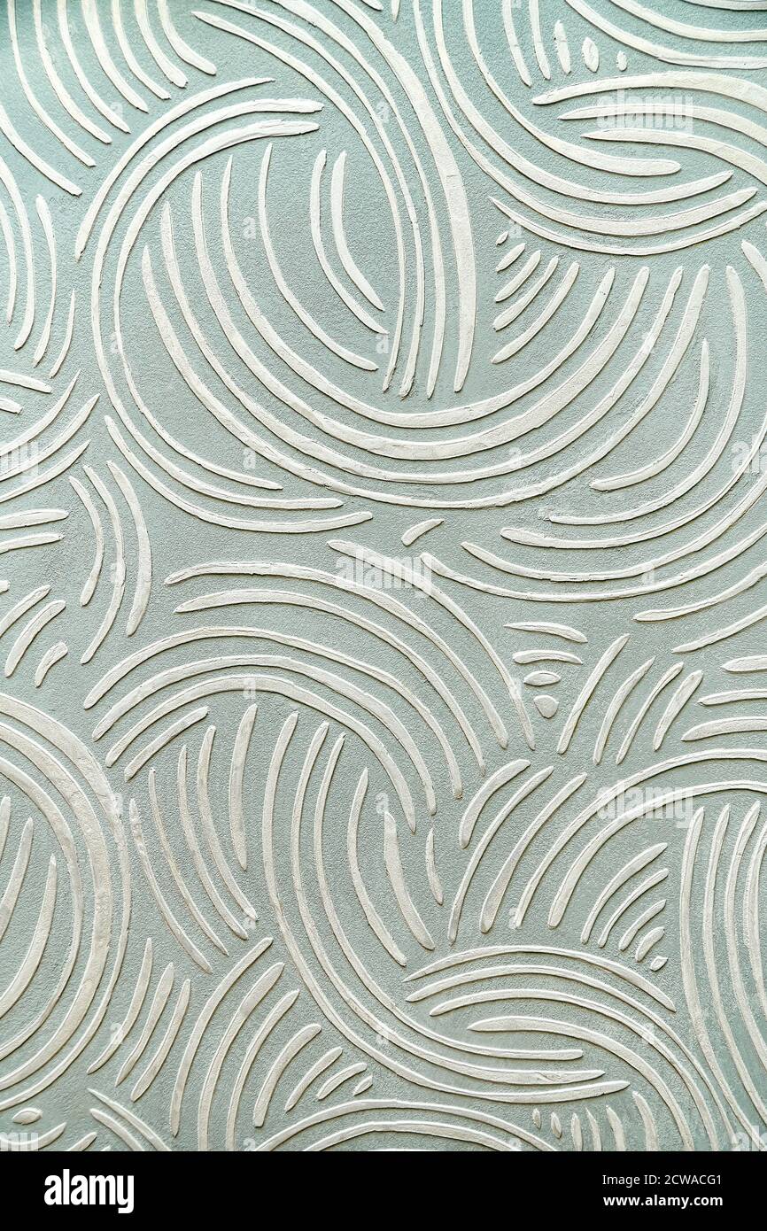 Decorative relief plaster with a unique pattern on wall. Close-up Stock Photo