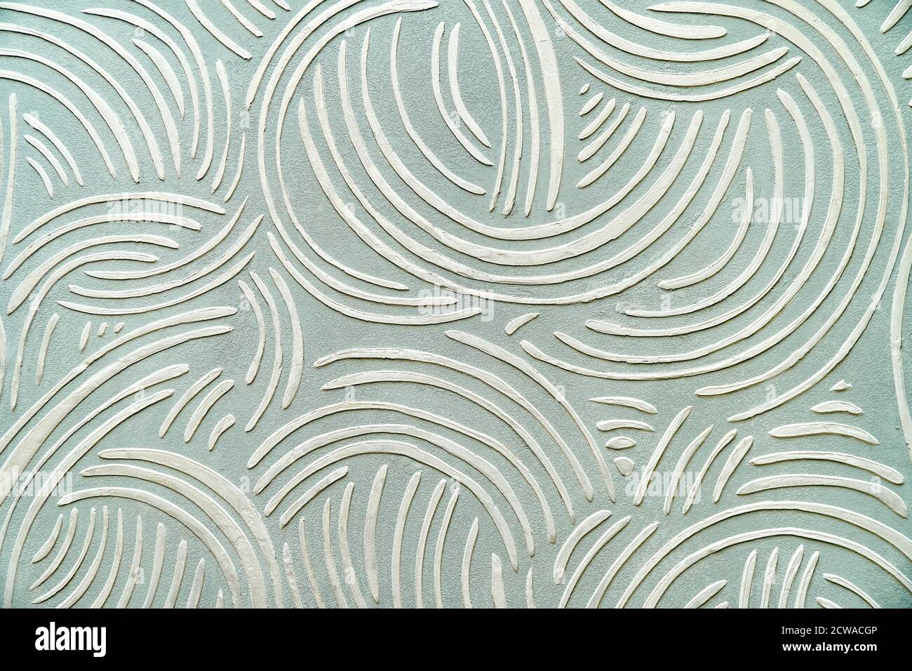 Decorative relief plaster with a unique pattern on wall. Close-up Stock Photo