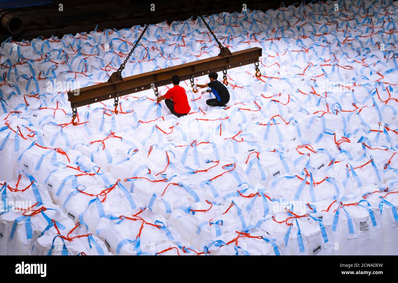 Overhead crane lift jumbo bags of tapioca using spread bar in storage