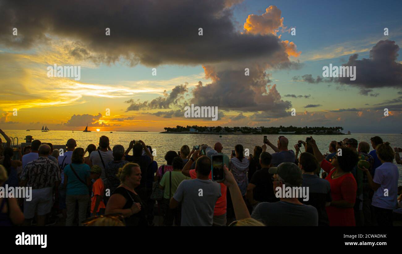 Tourists enjoy a spectacular Sunset from Sunset Pier, Key West Florida [for some strange reason the clap when the sun passes the horizon] Stock Photo